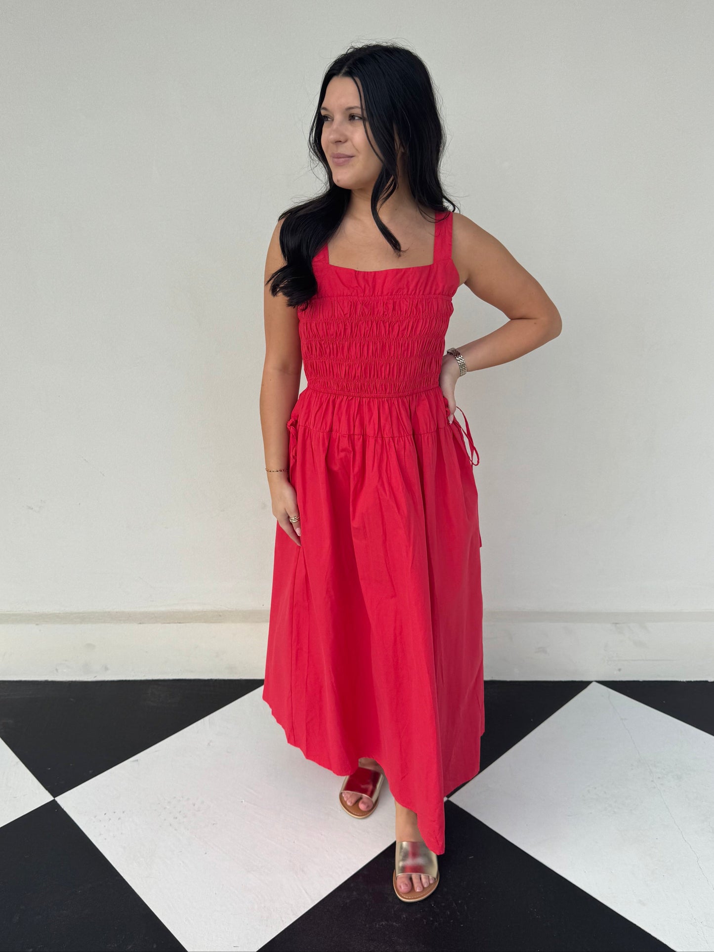 poppy red dress with ruched bodice, thick spaghetti straps, tie decorative detail on side and midi to maxi length.